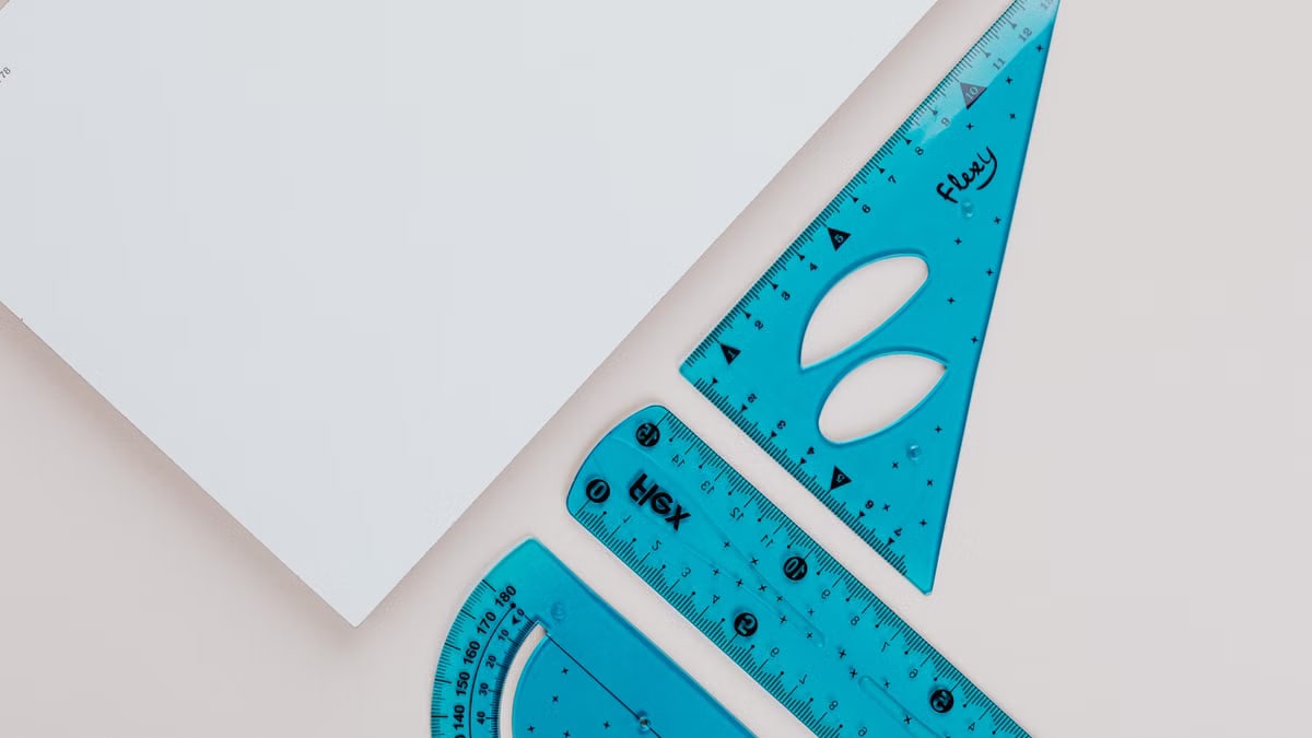 Close-up image of blue geometry tools on white background for educational use.